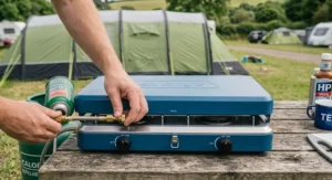 Demonstration of connecting a butane gas canister to a tabletop double burner camping stove.