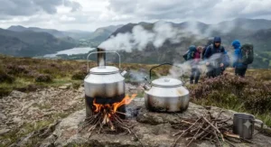 Both Kelly Kettle and Ghillie Kettle boiling water simultaneously during a windy British hillwalking expedition.