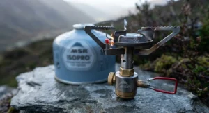 Focus on the pressure regulator and built-in igniter of the MSR PocketRocket Deluxe stove.