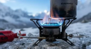 Close-up of the intense blue flame of a multi-fuel stove for expedition camping, demonstrating optimal heat output for high-altitude conditions.